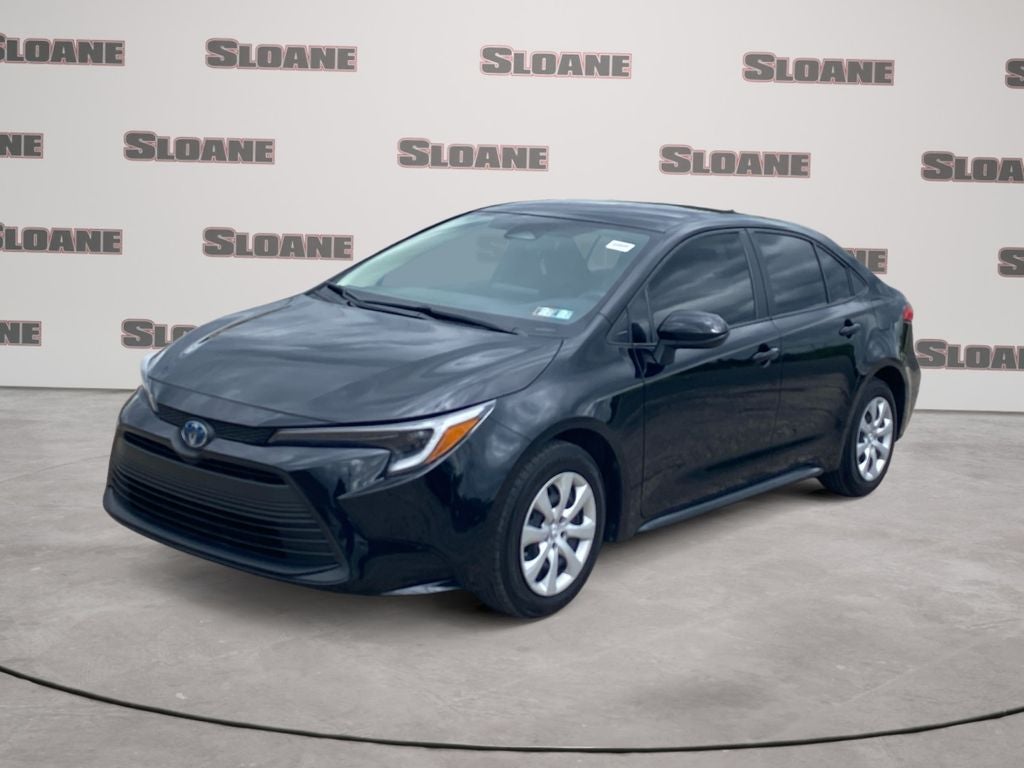 2025 Toyota COROLLA HYBRID LE in Midnight Black Metallic — front three-quarter view