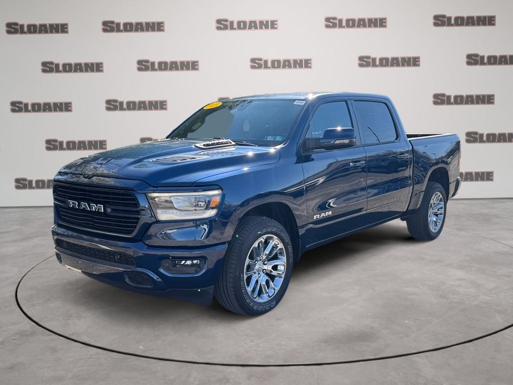 2023 RAM 1500 Laramie in Patriot Blue Pearlcoat — front three-quarter view