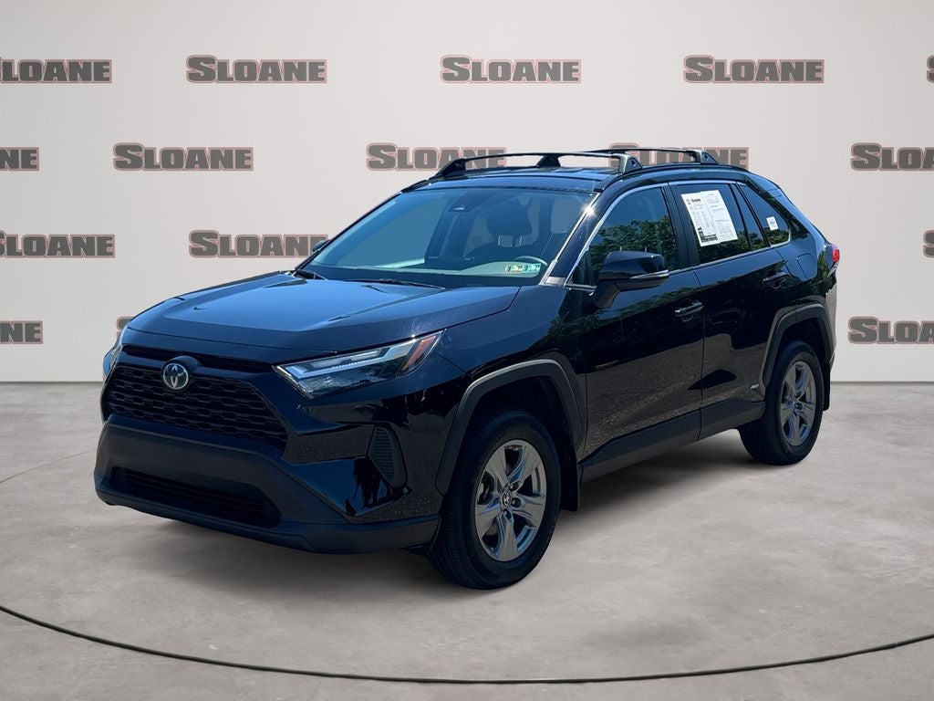 2024 Toyota RAV4 Hybrid LE in Midnight Black Metallic — front three-quarter view